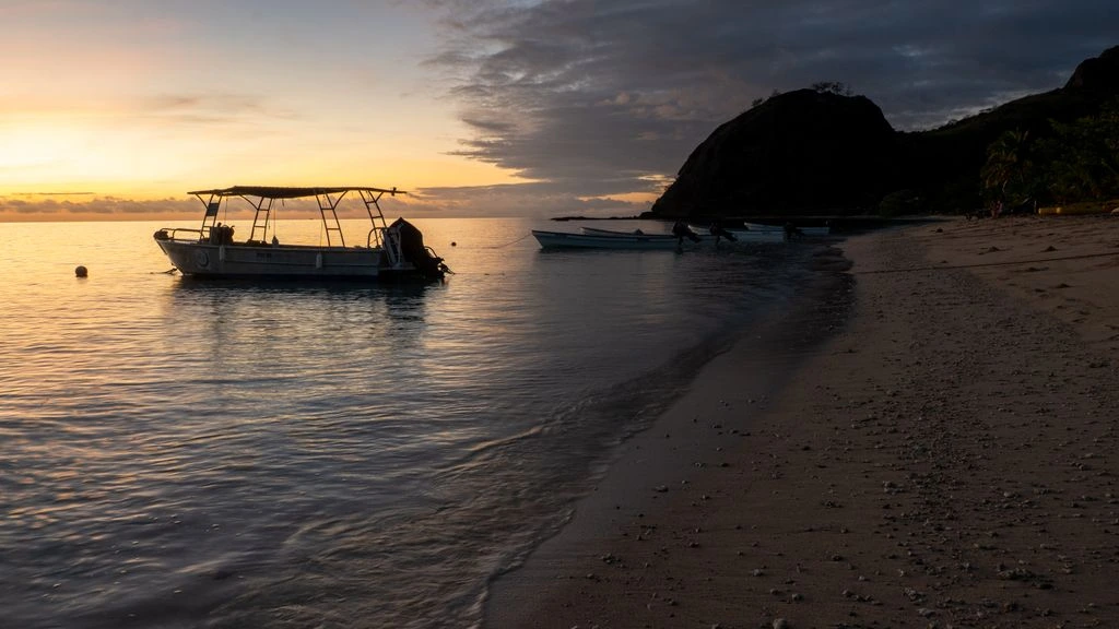 The original Silent World dive boat tied quietly to the Garden Cove Marina dock at sunrise.